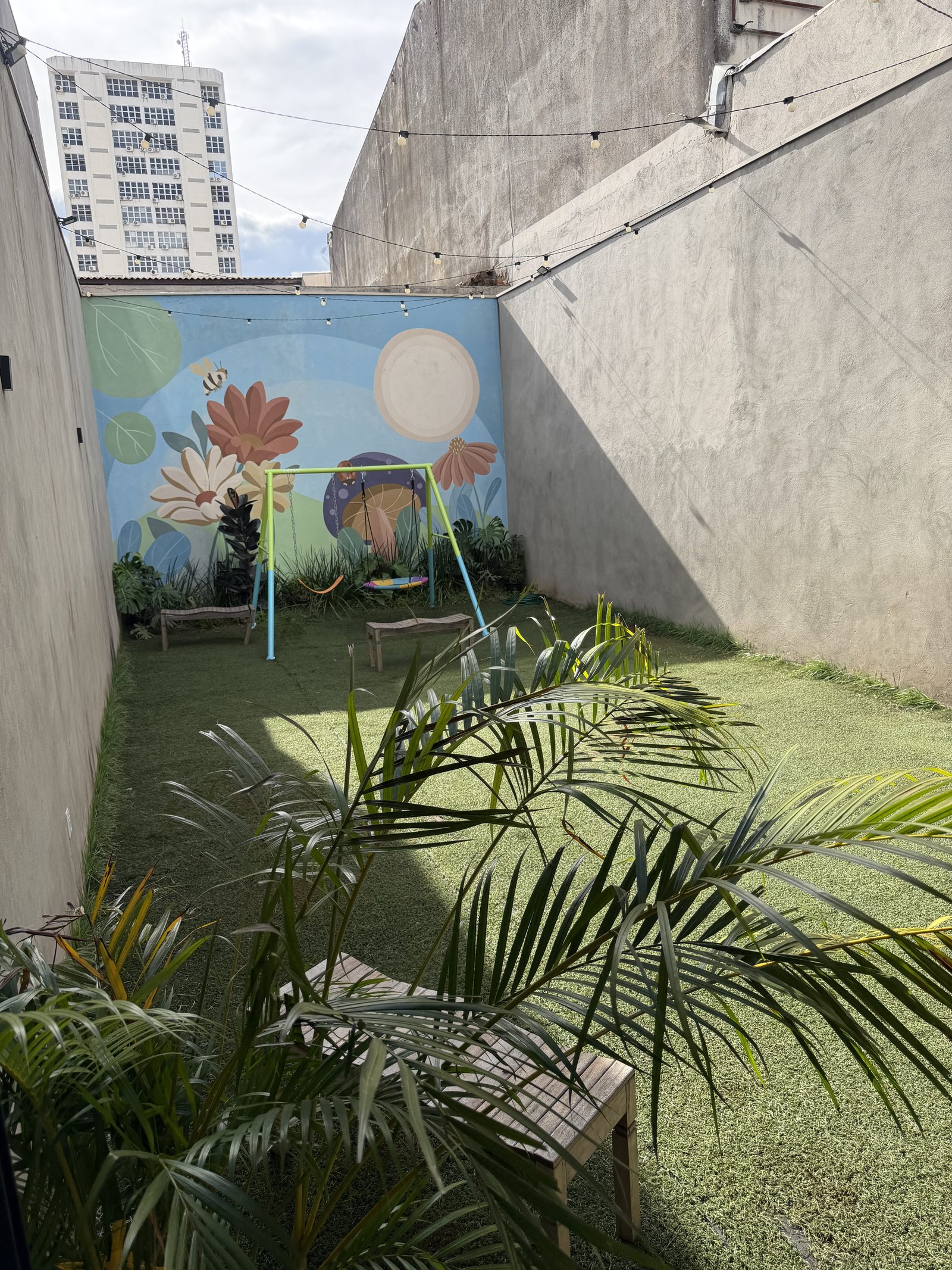 Área externa com gramado e mural
